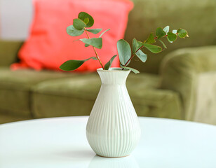 White Vase with Eucalyptus Sprigs on a Table