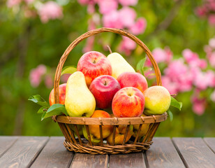 Wicker Basket of Ripe Apples and Pears on Wooden Table