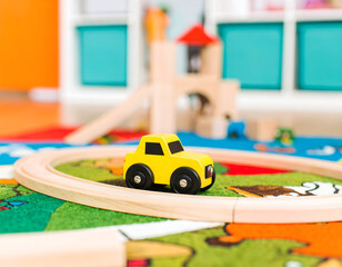 Yellow Wooden Toy Car on Track in Playroom
