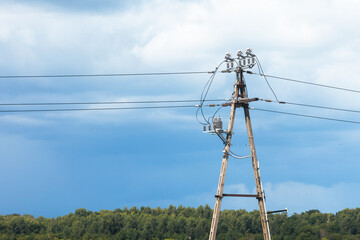 Electricity Pole and Power Lines Against Stormy Sky in Rural Landscape