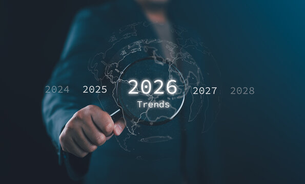 Future trend discovery concept in technology and business for 2026, a businessman explores upcoming global opportunities with magnifying glass and search for upcoming vacation destinations.
