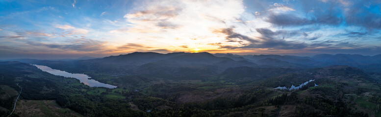 Panorama of Sunset over Mountains and Coniston Water from drone, Lake District National Park, Cumbria, England	