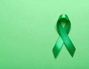 World Mental Health Day. A Green Ribbon on a Green Background.