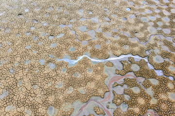 Texture of dry abandoned fish spawning bed in a lake,Dry and cracked ground land. Global warming...