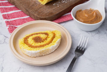 Roll cake or swiss cake filled with dulce de leche