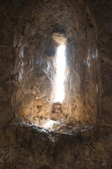 Awesome view of the Kizil Kule (Red Tower) from fortress walls of Alanya Castle in Turkey. The Mediterranean Sea is visible in background. The octagonal red brick tower is a popular tourist attraction