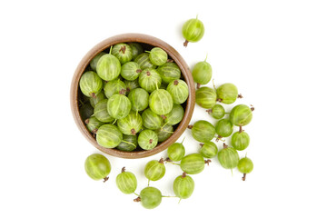 Fresh green gooseberries in a wooden bowl, surrounded by scattered berries on a white background, showcasing vibrant colors and natural textures for culinary inspiration