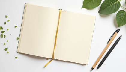 Top view spiral notebook with pencil and leaves