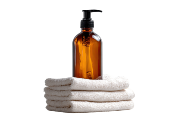 Amber glass pump bottle atop folded white towels