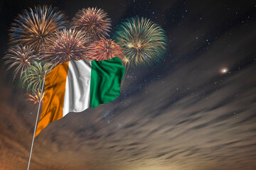 Waving National flag of Cote d Ivoire and holiday fireworks