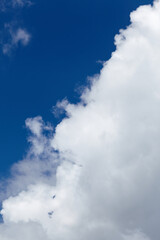 Bright blue sky with fluffy white clouds creating a serene atmosphere, showcasing the beauty of nature and the tranquility of a clear day in the open air
