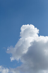 Fluffy white clouds against a bright blue sky create a serene atmosphere, showcasing the beauty of nature and the tranquility of a clear day with copy space
