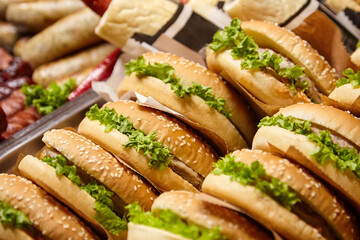 Freshly prepared sesame seed buns filled with crisp lettuce and savory ingredients, arranged neatly...