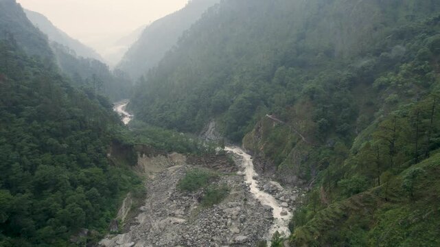 A view of the Mandakini River flowing through the valley between mountains, as seen during the trek to Kedarnath Temple in Kedarnath, Uttarakhand, India.	