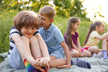 Children spending time in nature on summer day, selective focus