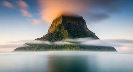 Lush Green Island Peak Emerging from Calm Ocean Mist at Sunrise.