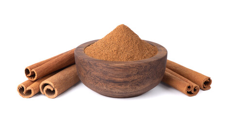 Dry cinnamon sticks on a white background. Cinnamon powder in a spoon.
