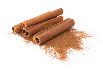 Dry cinnamon sticks on a white background. Cinnamon powder in a spoon.
