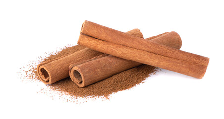 Dry cinnamon sticks on a white background. Cinnamon powder in a spoon.