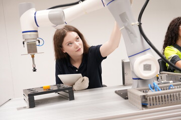 female engineers workshop programming software for automated manufacturing technology and for use...