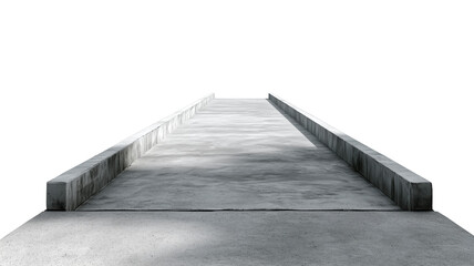 A narrow concrete walkway with side rails and shadows