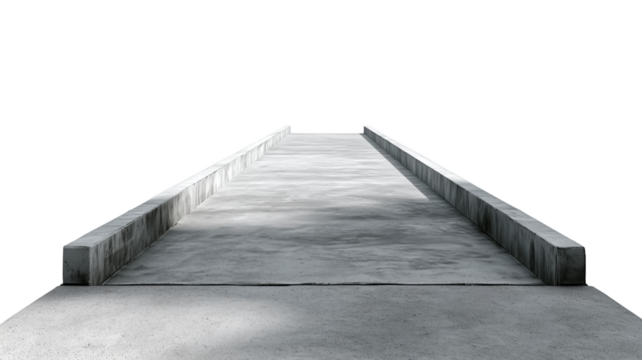 A narrow concrete walkway with side rails and shadows