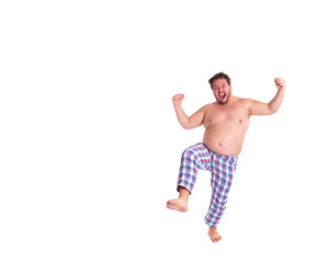 Early morning. Funny fat man in pajamas.