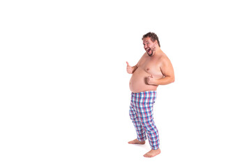 Early morning. Funny fat man in pajamas.