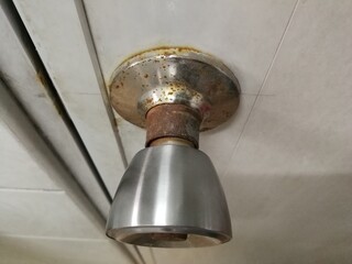 Bathroom door knob with rust and corrosion.