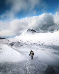 man reaching the top of a mountain