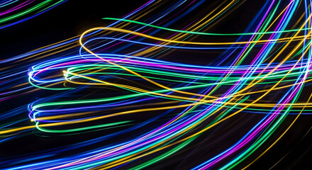 Dynamic Light Painting: Swirling Neon Trails on Black Canvas Abstract Energy.