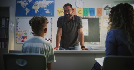 Male Teacher Giving School Exam Results of Primary School Student to His Mother. Teacher Praising...