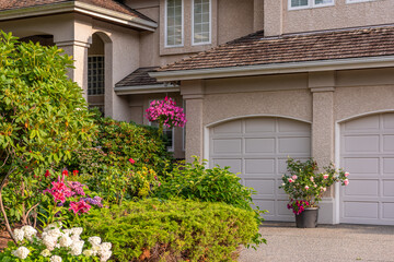 Garage door in luxury house with trees and nice landscape in Summer in Vancouver, Canada, North...