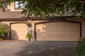 Garage door in luxury house with trees and nice landscape in Summer in Vancouver, Canada, North...