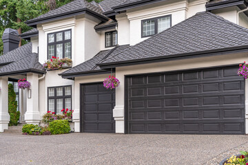 Garage door in luxury house with trees and nice landscape in Summer in Vancouver, Canada, North...