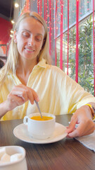 Woman Drinking Fruit Tea in Japanese Cafe