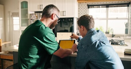 Distance learning, study or tablet with father and son in kitchen for homeschooling or lesson. App, education or teaching with single parent man and boy student in apartment for development from back - Powered by Adobe