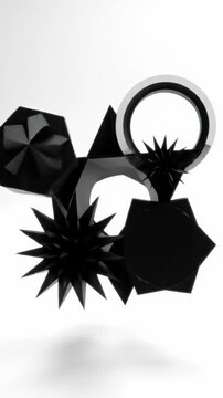 matte black geometric shapes (circle, hexagon, starburst, decagon) converge on an infinite pure white background, forming an abstract pattern captured with a high-angle flat lay video, showcasing