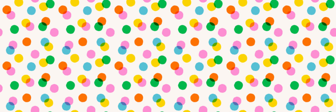 Colorful polka dot pattern background with overlapping circles in pink, green, orange, yellow and blue on a light background. Confetti pattern design for fabric, wrapping, wallpaper. Drag to swatches.