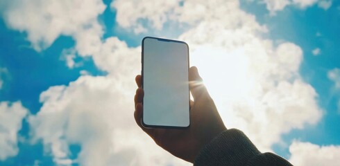 Capture Nature, Person Holds Device Against Sky with Clouds and Sunshine