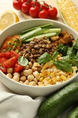 Healthy vegetarian food. Delicious Buddha bowl and ingredients on table, closeup