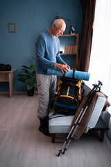 Travel. Elderly man packing backpack to hike travel. tourism,vacation and hiking