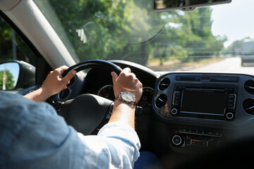 Man driving car with steering wheel, closeup