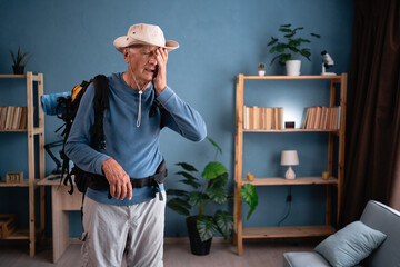 Retired traveler with backpack put hand on face facepalm fail mistaken omg gesture at home. Tourist...