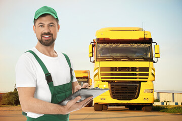 Car service worker with clipboard and trucks outdoors