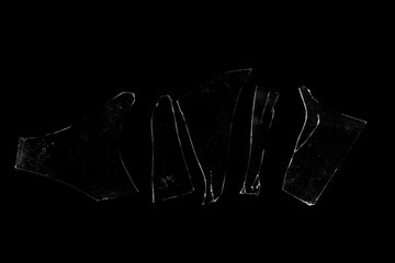 Several pieces of broken glass on a black background.