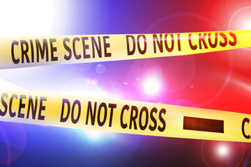 Police red and blue lights and yellow Crime Scene Do Not Cross tape