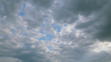 A Dramatic Cloudy Sky with Beautiful Blue Patches of Light Illuminating the Atmosphere