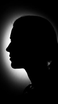 Silhouette Portrait: Mysterious Woman in Profile, Underexposed Lighting Creating Dramatic Facial Contours