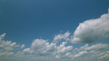 Time lapse. A Beautiful Serene Sky Filled with Fluffy Clouds in a Bright Blue Atmosphere Above Us